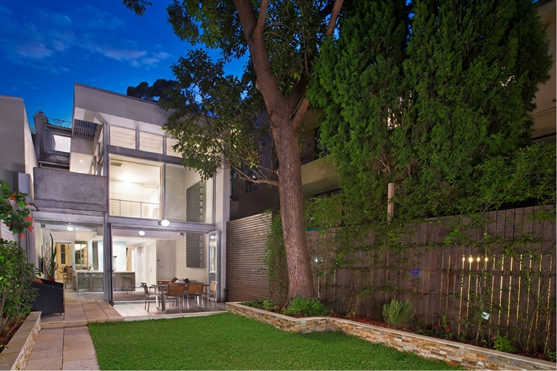 Contemporary residential rear facade opening to a landscaped courtyard